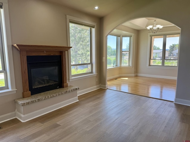 1252 Peppertree Dr, Montrose, CO 81401 - unfurnished living room featuring wood finished floors, baseboards, plenty of natural light, and recessed lighting