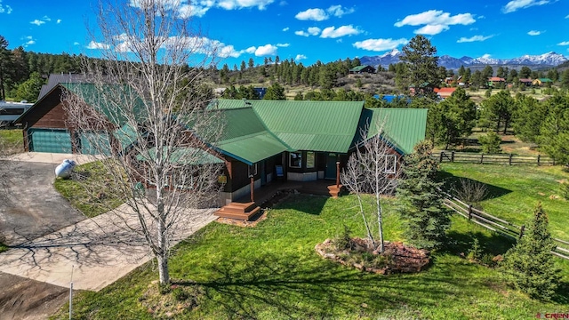 49 Sugarloaf Dr, Pagosa Springs, CO 81147 - view of front of house with metal roof, covered porch, a garage, a mountain view, and concrete driveway