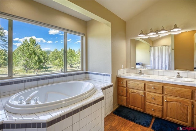 49 Sugarloaf Dr, Pagosa Springs, CO 81147 - bathroom with double vanity, a garden tub, wood finished floors, a shower with shower curtain, and lofted ceiling
