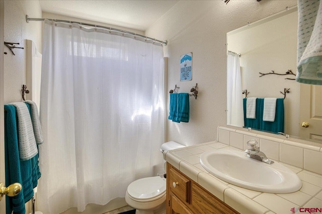 49 Sugarloaf Dr, Pagosa Springs, CO 81147 - full bathroom featuring vanity, toilet, shower / bath combo with shower curtain, and a textured wall