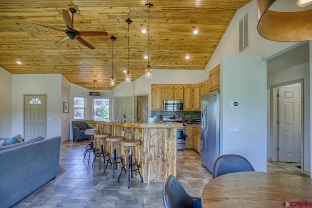 49 Sugarloaf Dr, Pagosa Springs, CO 81147 - kitchen with appliances with stainless steel finishes, wood ceiling, open floor plan, ceiling fan, and a kitchen island