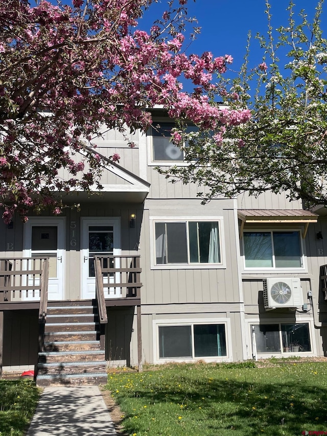 516 N 14th St Unit A, Gunnison, CO 81230 - view of front facade with ac unit, covered porch, and a front lawn