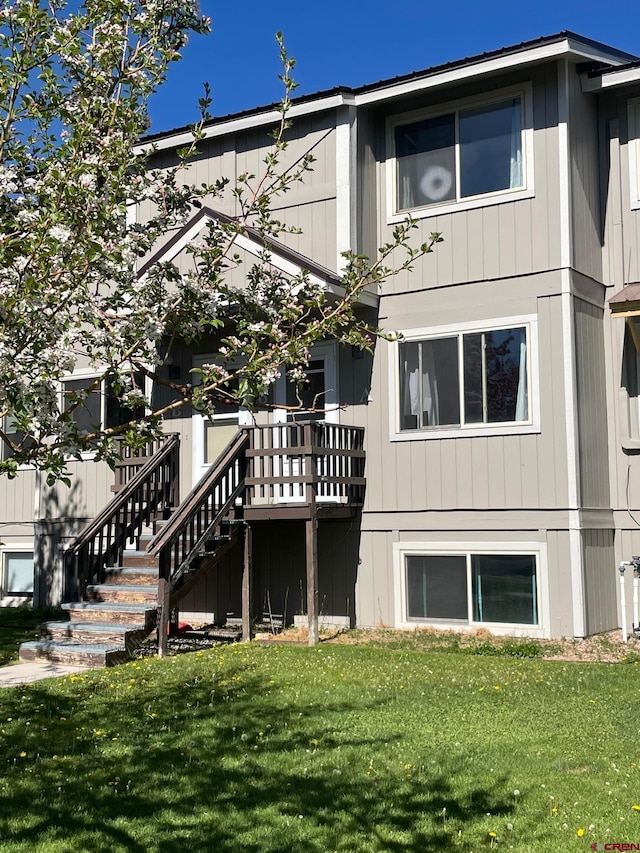 516 N 14th St Unit A, Gunnison, CO 81230 - back of house with a lawn and stairs
