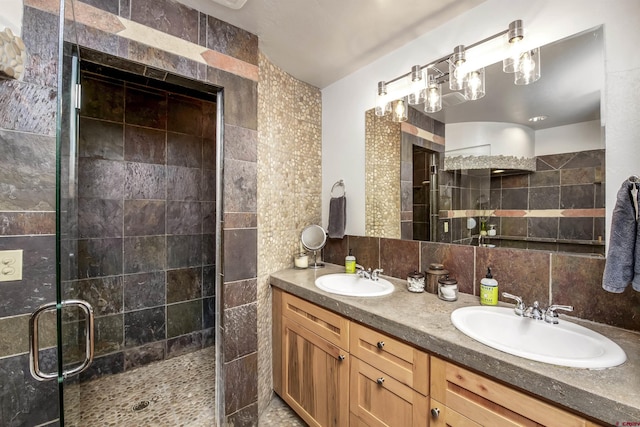 190 Teocalli Rd, Crested Butte, CO 81224 - bathroom featuring a shower stall, double vanity, tile walls, and decorative backsplash