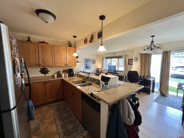 540 Redcliff Cir # E-104, Ridgway, CO 81432 - kitchen with appliances with stainless steel finishes, a peninsula, a sink, pendant lighting, and a breakfast bar area