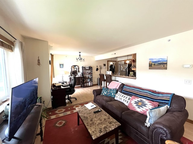 540 Redcliff Cir # E-104, Ridgway, CO 81432 - living room featuring a desk, wood finished floors, plenty of natural light, and a chandelier