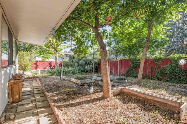 1615 Maple Ct, Grand Junction, CO 81505 - fenced backyard featuring a vegetable garden