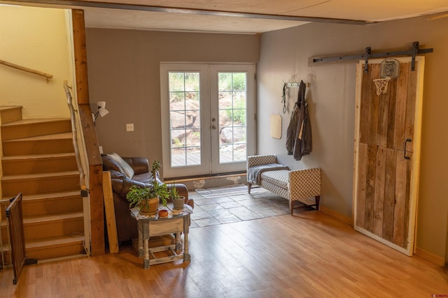 51 Blake St, Placerville, CO 81430 - entrance foyer with stairs, light wood-style flooring, french doors, a barn door, and baseboards