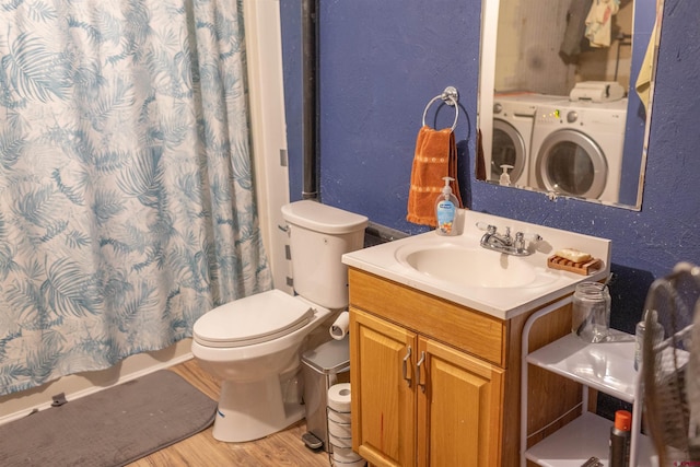 51 Blake St, Placerville, CO 81430 - full bath with washing machine and clothes dryer, wood finished floors, vanity, toilet, and a shower with shower curtain