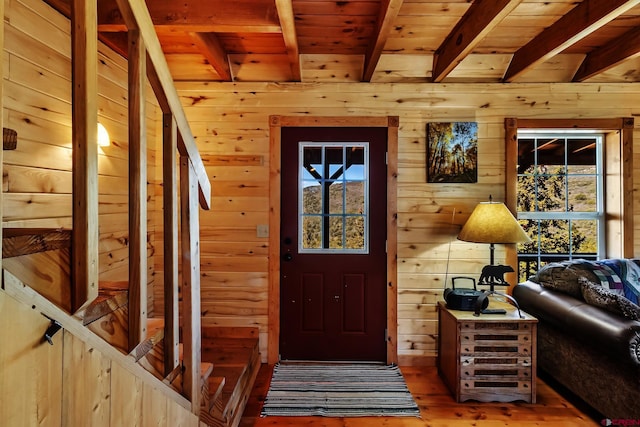 LOT7 Aspen Hills Rd, Cedaredge, CO 81413 - entrance foyer with wooden ceiling with exposed beams, wooden walls, and light wood-style floors