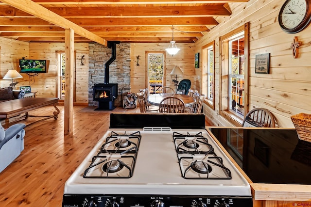 LOT7 Aspen Hills Rd, Cedaredge, CO 81413 - kitchen with white gas range, wooden walls, open floor plan, a wood stove, and wood-type flooring