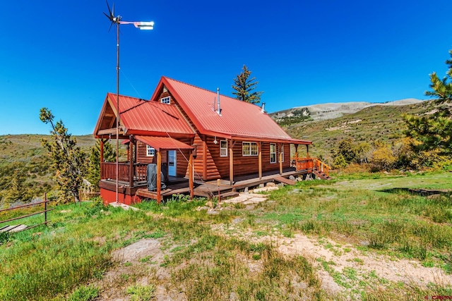 LOT7 Aspen Hills Rd, Cedaredge, CO 81413 - rear view of property with a deck with mountain view, log veneer siding, and metal roof