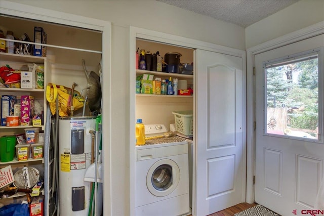 43 W Radiant Ct, Pagosa Springs, CO 81147 - laundry room featuring washer / dryer, electric water heater, and a textured ceiling