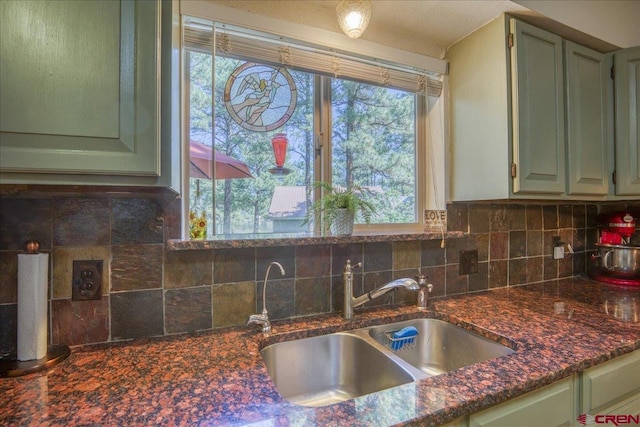 43 W Radiant Ct, Pagosa Springs, CO 81147 - kitchen featuring a sink, tasteful backsplash, and green cabinetry
