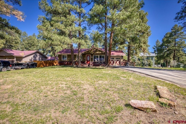 43 W Radiant Ct, Pagosa Springs, CO 81147 - single story home with asphalt driveway, an attached garage, and a porch