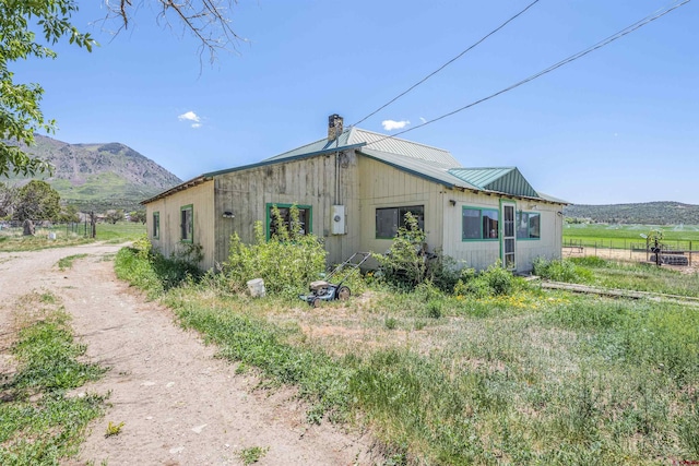 42254 Piburn Flats Rd, Crawford, CO 81415 - view of side of home featuring a chimney, metal roof, and a mountain view