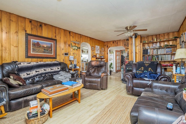 42254 Piburn Flats Rd, Crawford, CO 81415 - living room featuring arched walkways, a ceiling fan, wood walls, and wood finished floors