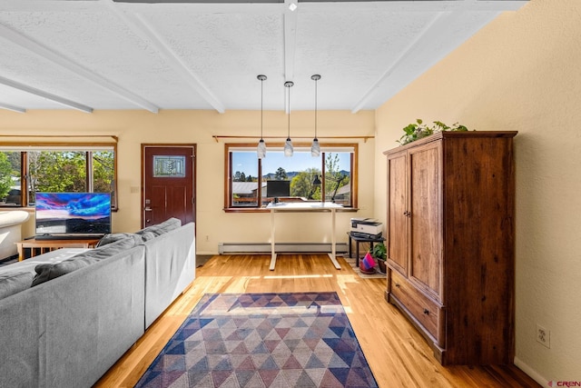 2503 Borrego Dr, Durango, CO 81301 - living area with a baseboard radiator, light wood-style floors, a textured ceiling, beamed ceiling, and plenty of natural light