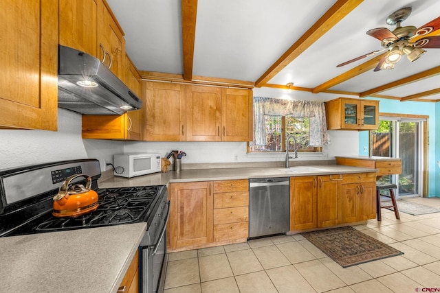 2503 Borrego Dr, Durango, CO 81301 - kitchen with appliances with stainless steel finishes, under cabinet range hood, beamed ceiling, light tile patterned floors, and light countertops