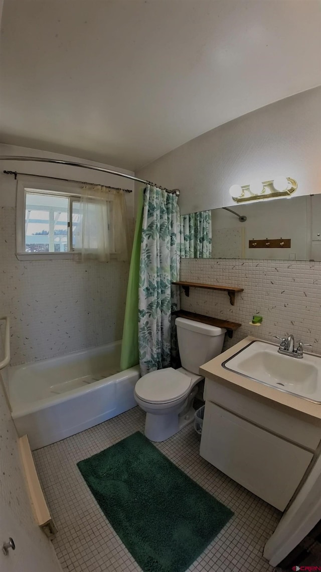 17992 Hanson Rd, Cedaredge, CO 81413 - full bathroom with shower / tub combo, toilet, vanity, tile patterned floors, and tile walls
