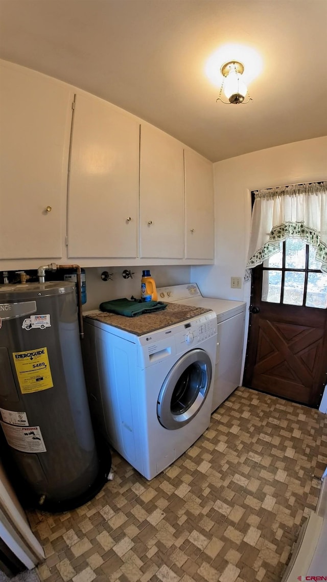 17992 Hanson Rd, Cedaredge, CO 81413 - laundry room featuring water heater, washing machine and dryer, and cabinet space