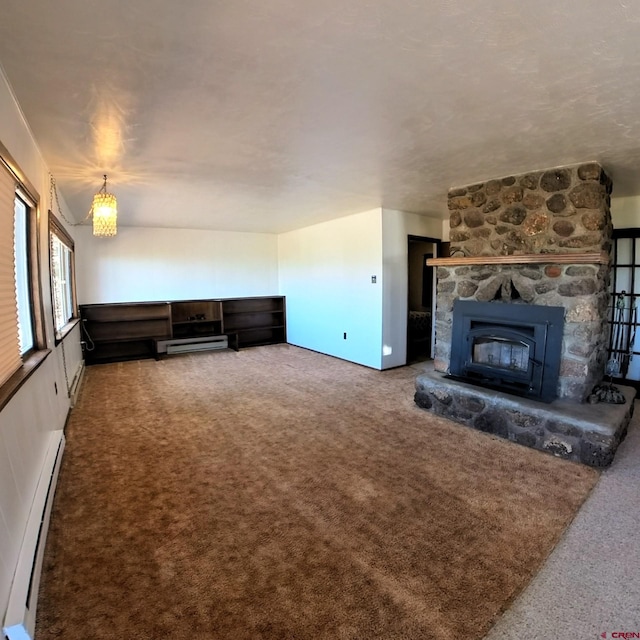17992 Hanson Rd, Cedaredge, CO 81413 - unfurnished living room with carpet flooring, baseboard heating, and a fireplace