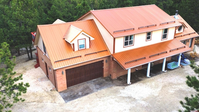 1625 Keepsake Loop, Westcliffe, CO 81252 - view of front of house with metal roof, driveway, a garage, and a wooded view