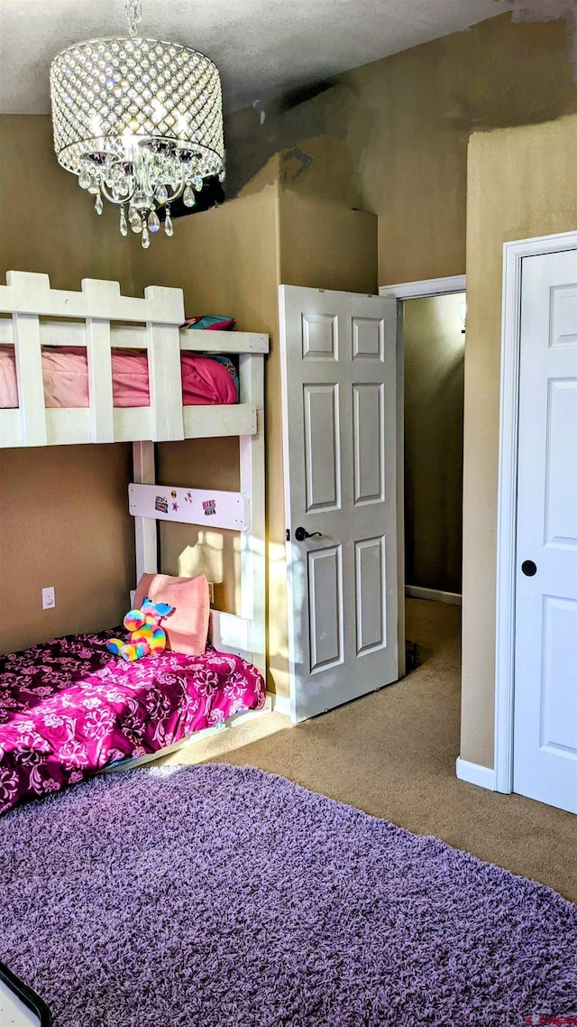 1625 Keepsake Loop, Westcliffe, CO 81252 - carpeted bedroom with a chandelier and baseboards