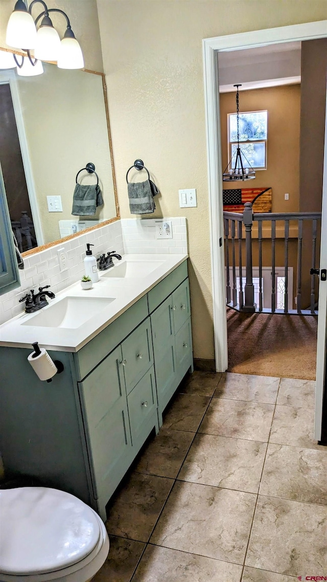 1625 Keepsake Loop, Westcliffe, CO 81252 - full bath with a chandelier, double vanity, tasteful backsplash, and tile patterned flooring