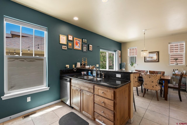 236 Sierra Vista St, Durango, CO 81301 - kitchen with dishwasher, a sink, a peninsula, light tile patterned floors, and hanging light fixtures
