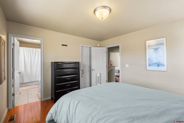 236 Sierra Vista St, Durango, CO 81301 - bedroom with wood-type flooring, ensuite bath, and baseboards