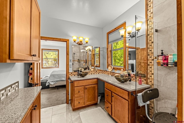 380 Eagle Pass, Durango, CO 81301 - ensuite bathroom with a chandelier, vanity, tile patterned floors, and a shower
