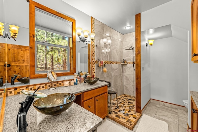 380 Eagle Pass, Durango, CO 81301 - bathroom with a walk in shower, double vanity, toilet, a chandelier, and baseboards