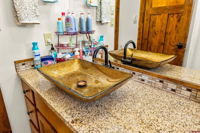 380 Eagle Pass, Durango, CO 81301 - kitchen with a sink, light stone countertops, and brown cabinetry