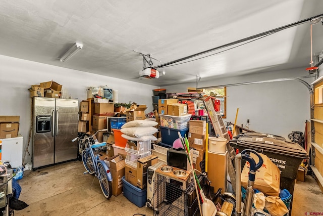 380 Eagle Pass, Durango, CO 81301 - garage featuring stainless steel fridge and a garage door opener