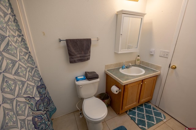 13569 3100th Rd, Hotchkiss, CO 81419 - bathroom featuring vanity, toilet, tile patterned flooring, and a shower with curtain