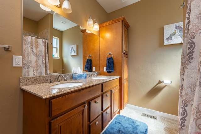 1607 S Taylor Cir, Bayfield, CO 81122 - full bath with double vanity, baseboards, and tile patterned floors