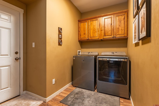 1607 S Taylor Cir, Bayfield, CO 81122 - laundry room featuring independent washer and dryer, cabinet space, light wood-style floors, and baseboards