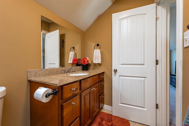 1607 S Taylor Cir, Bayfield, CO 81122 - half bathroom with vanity, vaulted ceiling, and toilet