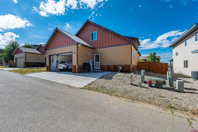 1607 S Taylor Cir, Bayfield, CO 81122 - view of front facade featuring board and batten siding, central air condition unit, driveway, and an attached garage