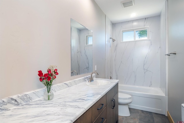 7 Yarrow Ct, Durango, CO 81301 - bathroom featuring toilet, vanity, shower / tub combination, and stone finish floors