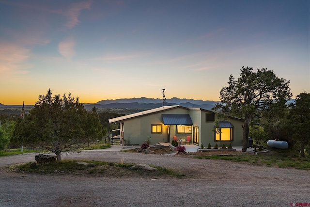 41 Ridge Pl, Durango, CO 81301 - mid-century modern home with stucco siding, curved driveway, and a mountain view