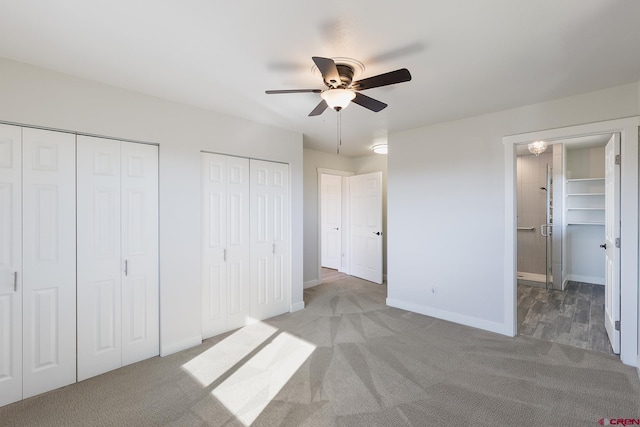 41 Ridge Pl, Durango, CO 81301 - unfurnished bedroom featuring two closets, light colored carpet, baseboards, and a ceiling fan
