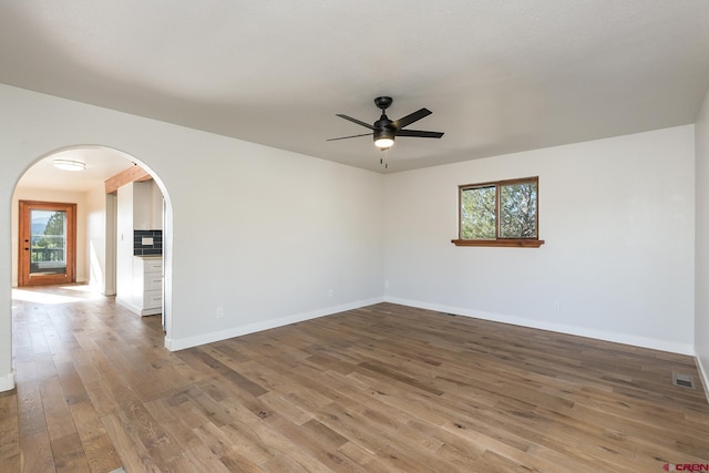 41 Ridge Pl, Durango, CO 81301 - unfurnished room with arched walkways, a ceiling fan, healthy amount of natural light, and wood finished floors