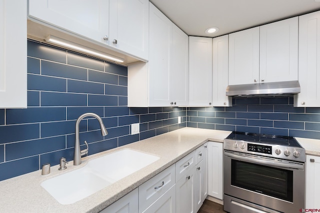 41 Ridge Pl, Durango, CO 81301 - kitchen featuring stainless steel range with electric cooktop, under cabinet range hood, a sink, and white cabinetry