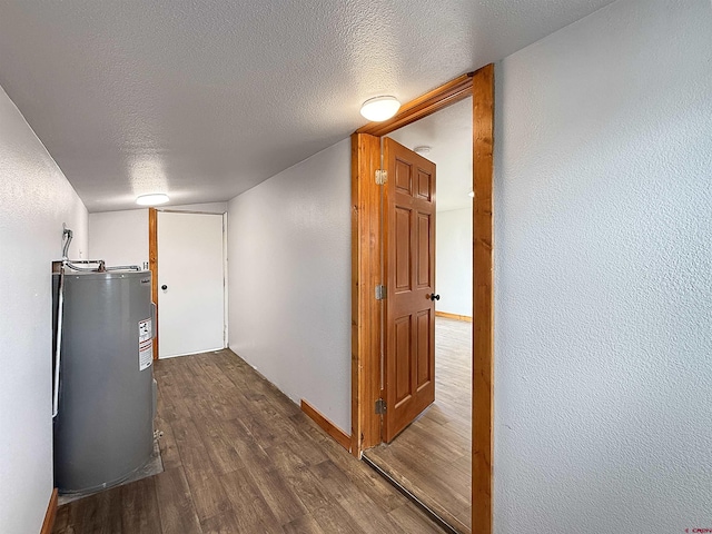 1246 Meeker St, Delta, CO 81416 - hall with water heater, dark wood-type flooring, a textured ceiling, and baseboards