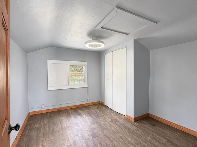 1246 Meeker St, Delta, CO 81416 - additional living space featuring vaulted ceiling, wood finished floors, baseboards, and attic access