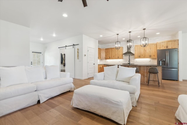 225 Hay Barn Rd, Durango, CO 81301 - living room with a barn door, recessed lighting, light wood finished floors, and ceiling fan