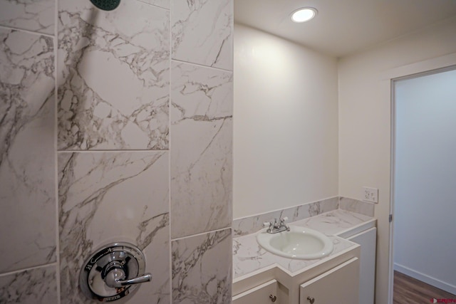 327/327.5 E 7th St, Walsenburg, CO 81089 - bathroom featuring a tile shower, vanity, wood finished floors, and recessed lighting