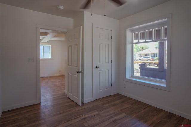 327/327.5 E 7th St, Walsenburg, CO 81089 - unfurnished bedroom with dark wood-style floors, baseboards, and ceiling fan